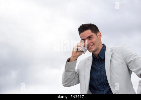 Young Latin man using mobile phone Stock Photo