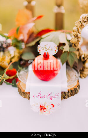 Sweet red pomegranate on the wedding table close up Stock Photo