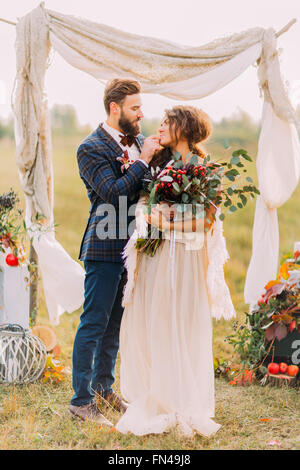 Happy couple softly hold each other on the wedding ceremony Stock Photo