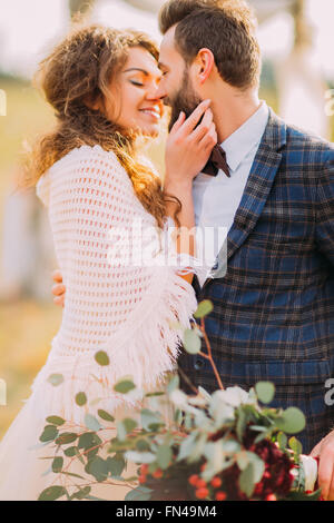 Happy wedding couple softly holding each other close  up Stock Photo