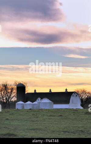 Day comes to a colorful end above a modern dairy farm in South Elgin, Illinois, USA. Stock Photo