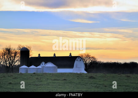 Day comes to a colorful end above a modern dairy farm in South Elgin, Illinois, USA. Stock Photo