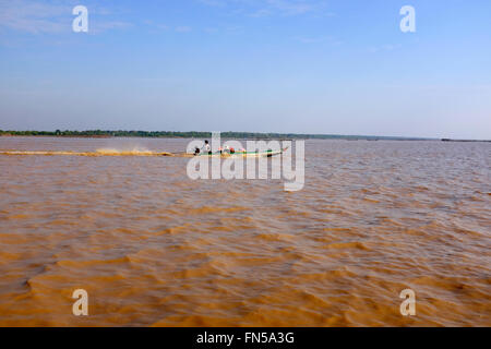 Small boat on a muddy Tonle Sap Lake in Cambodia Stock Photo