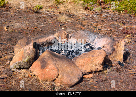 Camp Fire Rock Circle with Ash and Burnt Wood Stock Photo