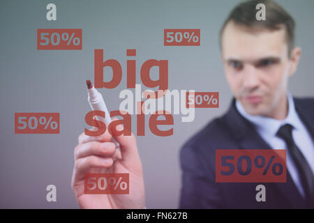 BIG SALE - Businessman writing text on a transparent board Stock Photo