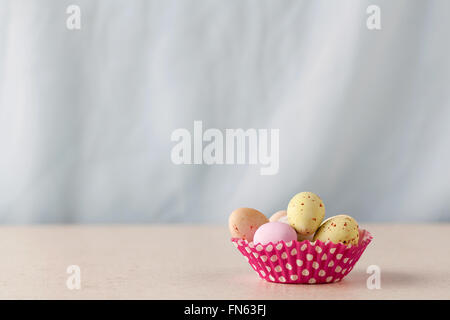 Chocolate speckled Easter eggs in a crisp sugar shell in cupcape liner with copy space Stock Photo