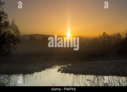Teesdale, County Durham. 14th March 2016. UK Weather.  A foggy and frosty start to the day created the right conditions for a sun pillar around sunrise this morning.  A sun pillar is caused by sunlight reflecting off tiny ice crystals suspended in the atmosphere. Credit:  David Forster/Alamy Live News Stock Photo