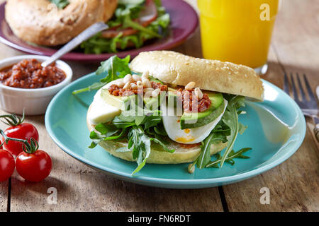 Fresh bagel sandwich on wooden table Stock Photo