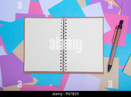 Open notebook on the background of colored stickers. Stock Photo