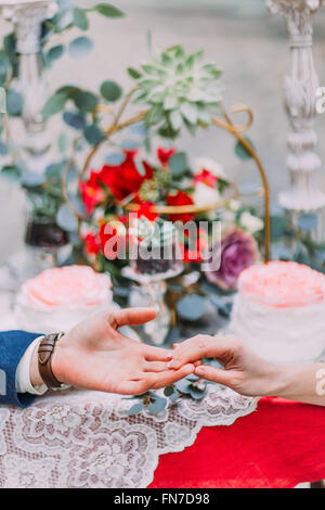 Happy wedding couple softly holding hands close up Stock Photo