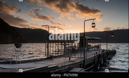 The Nice view of a sightseeing boat cruising on autumn Lake Towadako in Towada Hachimantai National Park Stock Photo