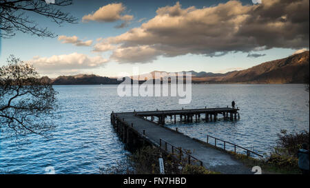 The Nice view of a sightseeing boat cruising on autumn Lake Towadako in Towada Hachimantai National Park Stock Photo