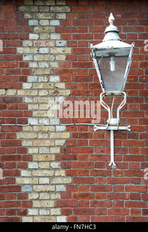 Old street light and brick wall pattern in Dorchester on Thames, Oxfordshire, England Stock Photo