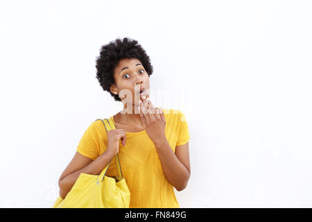 Closeup portrait of surprised young african woman standing against white background Stock Photo