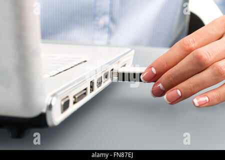 Female hand inserting flash drive. Stock Photo