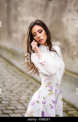 Business woman phone talking. Fashionable Young Woman  Busy with her Mobile Phone.  Portrait of young woman Stock Photo