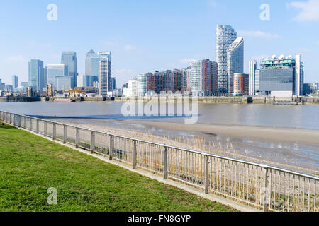 Canary wharf and docklands residential developments from the Thames path, Greenwich Peninsula, London, England, UK Stock Photo