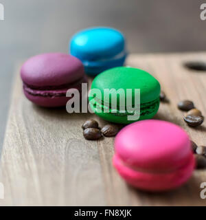 Colorful macaroons on wooden background, close up Stock Photo