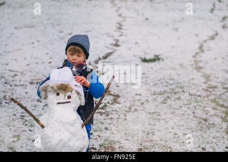 Boy making a snowman Stock Photo