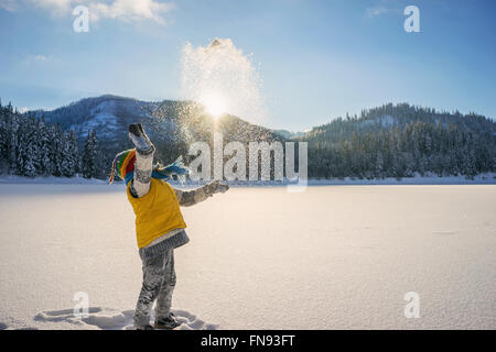 Boy throwing snow in the air Stock Photo