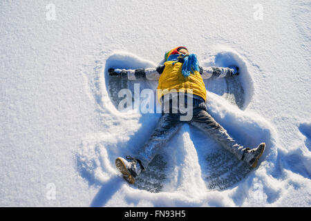 Boy making a snow angel Stock Photo