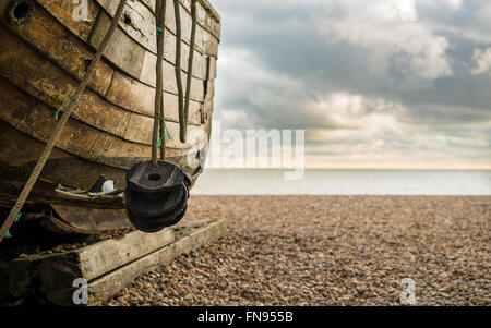 Old wooden fishing boat on Brighton beach,Sussex, UK Stock Photo