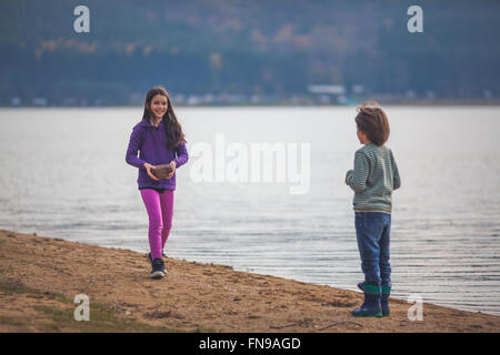 Boy and girl by a lake Stock Photo