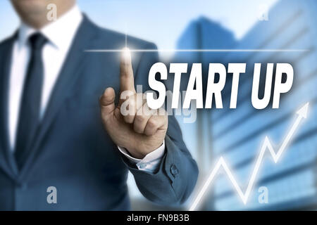 start up touchscreen is operated by businessman. Stock Photo