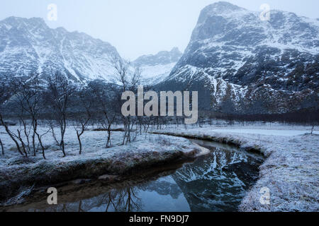 Snow covered mountains and river near Erdsfjordbotn, Tromso, Norway Stock Photo