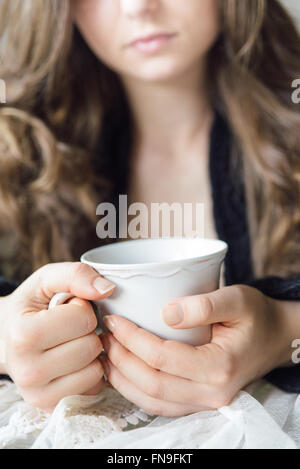 Young woman holding cup of tea Stock Photo