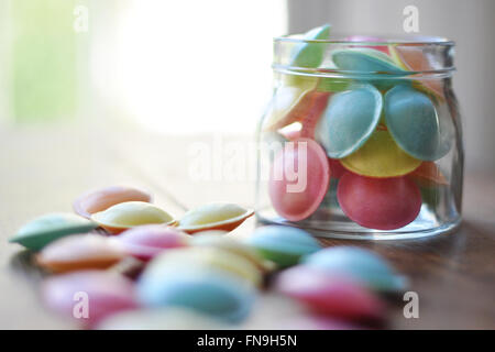 Jar of Pastel colored flying saucer sweets Stock Photo