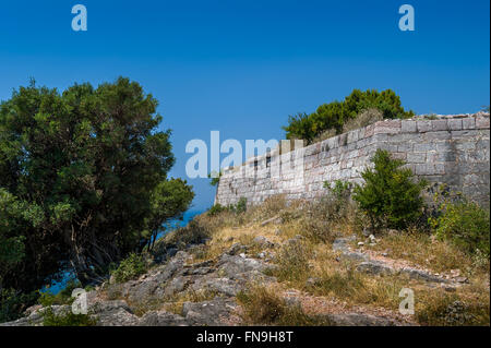 Stone walls of ancient fortress up the hill Stock Photo