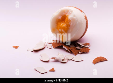 Soft boiled broken egg bleeding with yolk Stock Photo