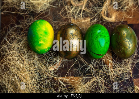Green painted Easter eggs in a row Stock Photo