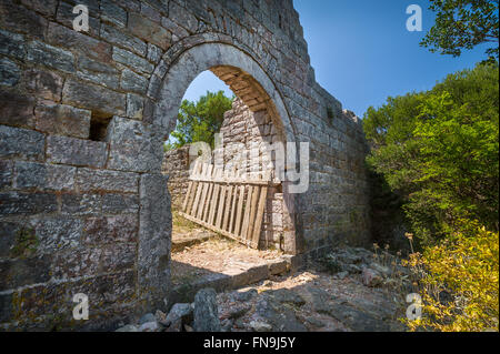 Old gate in a stone fortress wall Stock Photo