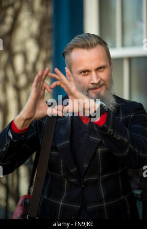 Hipster Man making heart shape with hands Stock Photo