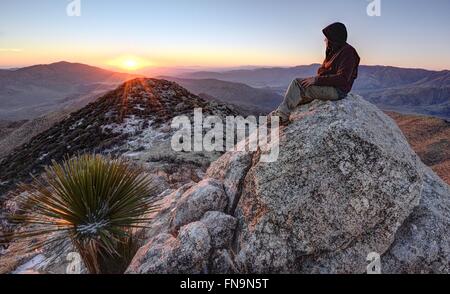 Man sitting on granite peak, Anza-Borrego Desert State Park, California, USA Stock Photo