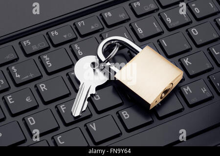 Computer security or safety concept. Laptop keyboard with lock and chain Stock Photo