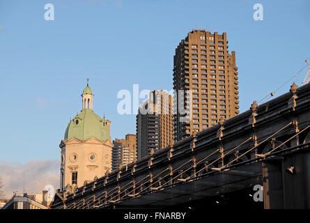 Barbican Estate Towers skyline buildings rising above Smithfield Market building cupola in The City of London England Great Britain UK KATHY DEWITT Stock Photo