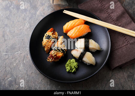 fresh sushi on black plate top view Stock Photo