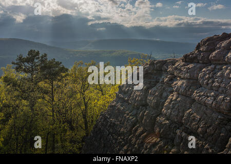 Cliff over looking rolling green mountains Stock Photo