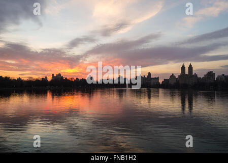 View of the Upper West Side, including the iconic towers of the Eldorado, across the Central Park reservoir at sunset. Stock Photo