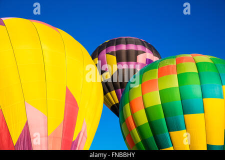 Abstract hot air balloons during lift off against the blue sky Stock Photo