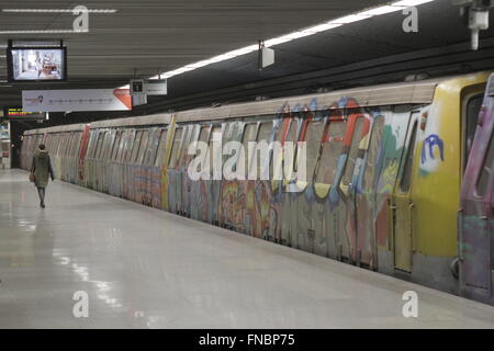 Bucharest, Romania, March 13, 2016: Passengers are traveling old trains of metro, covered by graffiti, in one of the newest line Stock Photo