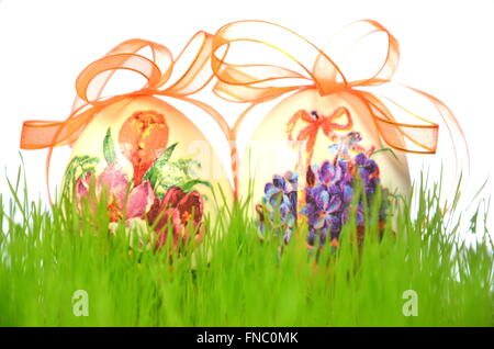 Easter eggs decorated with flowers made by decoupage technique in the grass Stock Photo