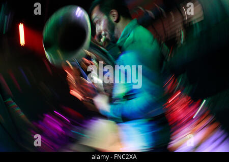 Colorful streaks swirl motion blur image of a tuba music organ player. 'WE' artspace, Thessalonica, Greece.