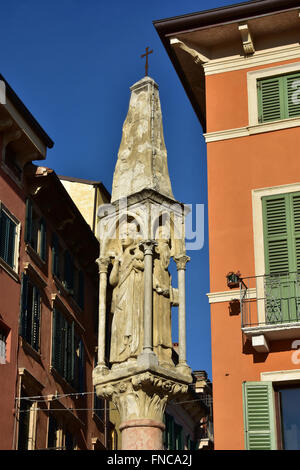 Typical medieval shrine in Verona next to the famous Arena, with Virgin Mary and Saint Anthony the great, the father of all monk Stock Photo