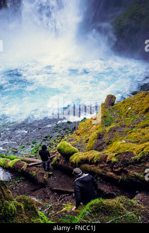 Two men explore Koosah Falls in Oregon along the historic McKenzie River. Stock Photo