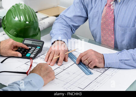 Detail of two designers who work in their studio with a project work plan. Closeup. Stock Photo