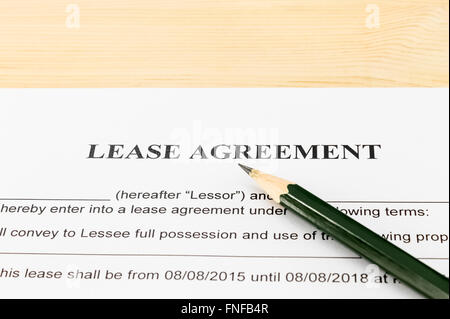 Lease Agreement Contract Document and Pencil Horizontal View on Wood Table in Vintage Style. Legal document for business event Stock Photo